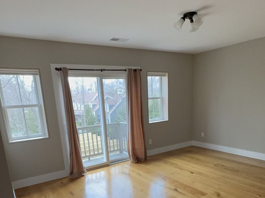 Freshly painted room with white ceiling and oak floor