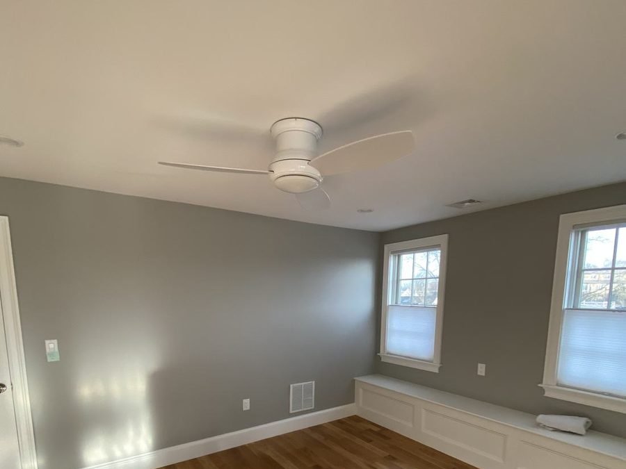 Living space with warm gray walls, crisp white trim and built-in bench seating