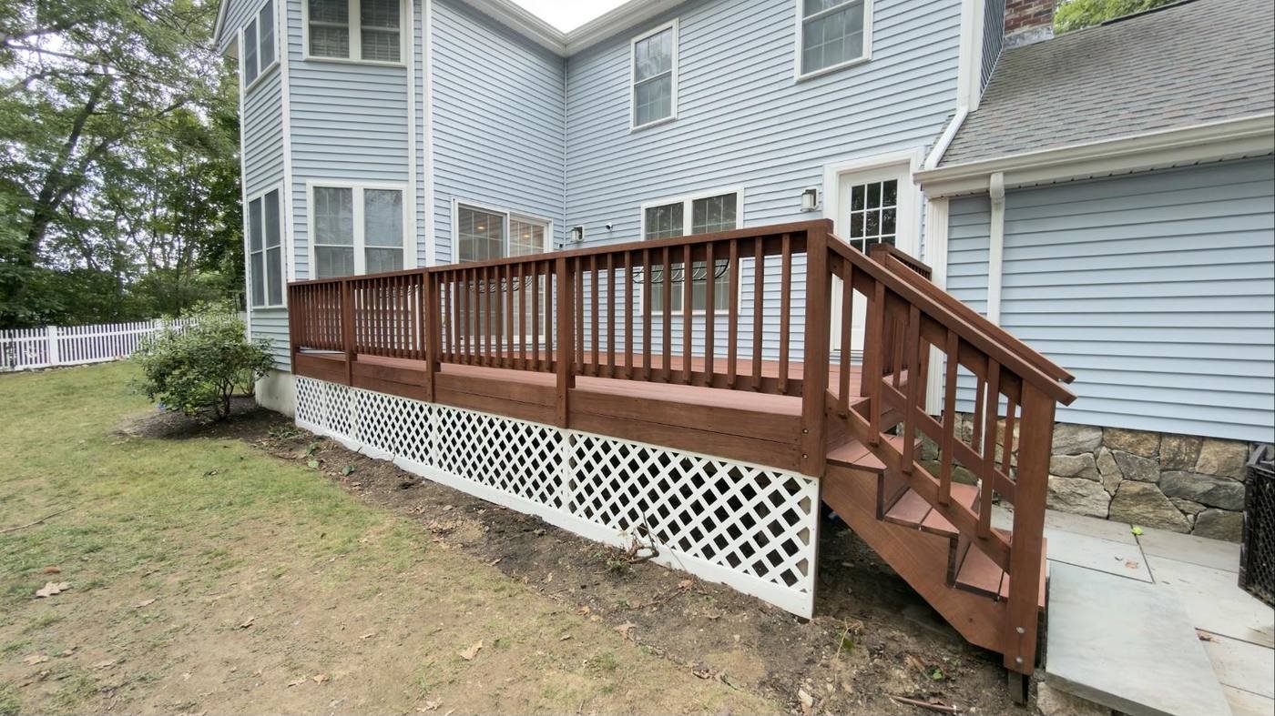 Rebuilt deck with a stained mahogany rail and freshly painted white lattice